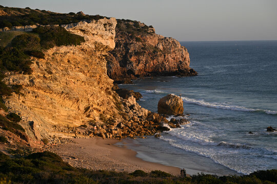 Warm sunset light bathes Praia do Zavial along the North Atlantic Ocean in the Algarve region of Portugal; Raposeira, Faro, Portugal