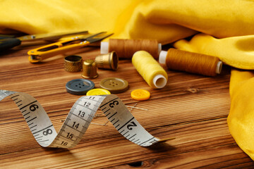 Crafting tools and materials arranged on a wooden table ready for sewing and creative projects