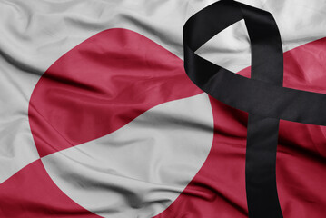 waving national flag of greenland with black mourning ribbon . tragedy concept