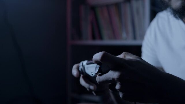 Hands of a person holding a joystick playing a videogame