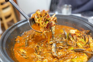 Spicy Anchovy Seasoned Salad: A Flavorful Korean Local Specialty with Marinated Anchovies and Fresh Vegetables.