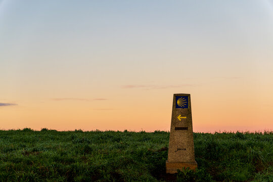 Sunrise on a Camino compostelle stone with distance, Spain