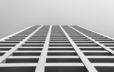 Minimalist black and white abstract photo. Low angle view of an apartment building in Osaka.