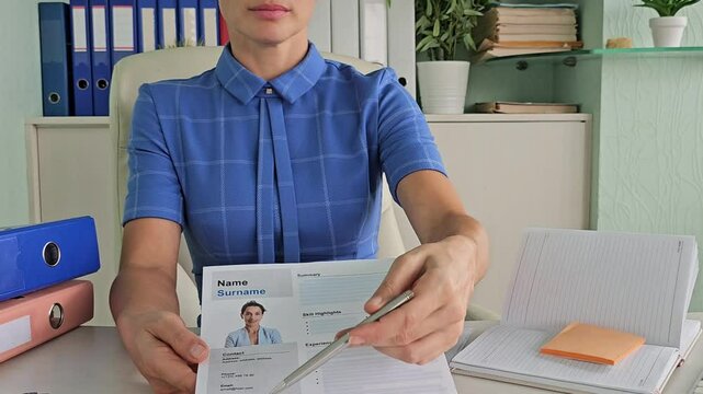 Business woman submits resume to employer for interview