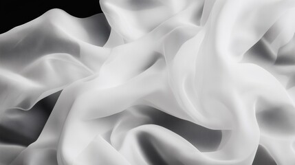 Obraz premium Delicate white fabric draped on a dark surface showcasing textures and softness in elegant detail