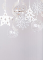 Christmas decorations, garland of transparent glass balls and shiny snowflakes with ribbons