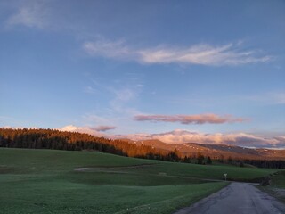 Country road surrounded by mountain sunset afterglow