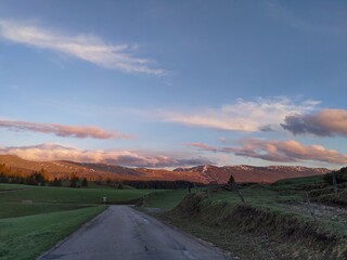 Country road surrounded by mountain sunset afterglow