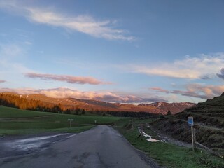 Country road surrounded by mountain sunset afterglow