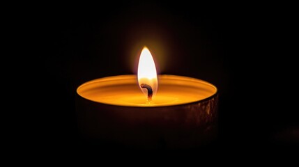 Candle glowing softly in a dark setting