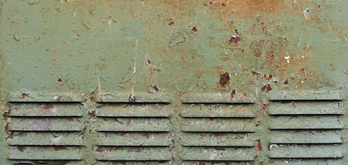 Rusty surface of louvre air vent. Detailed grungy texture of rusted steel ventilation grill. Weathered old panel with rust, chipped and peeling, aged iron, corrosion details, flaking fade green paint