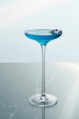 Blue Cocktail in a Tall Stem Glass with Flower Garnish