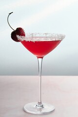 Red Cocktail with Cherry and Coconut Flakes