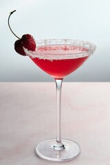 Red Cocktail with Cherry and Coconut Flakes