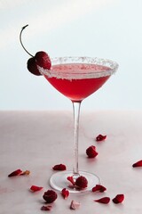 Red Cocktail with Cherry and Coconut Flakes
