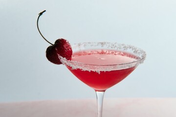 Red Cocktail with Cherry and Coconut Flakes
