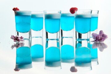 Blue Shot Cocktails with Foam and Floral Garnish
