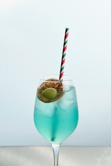 Blue Cocktail with Olive and Dehydrated Orange Slice