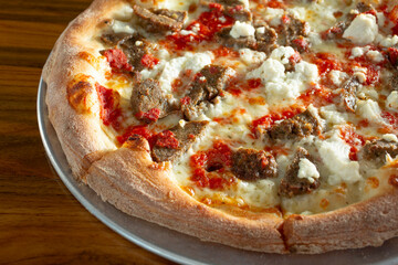 A view of a meatball and ricotta pizza.