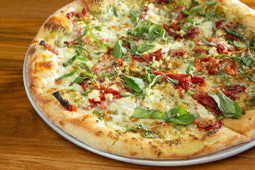 A view of a sun-dried tomato goat cheese pizza.