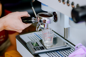 Measuring coffee with a scale. Measuring coffee affects the taste and aroma of the coffee beans.