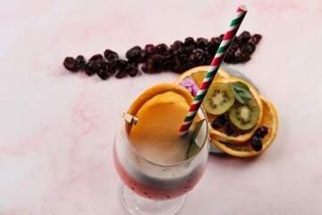 Refreshing Red Cocktail Garnished with Ice and Dried Fruit Chips
