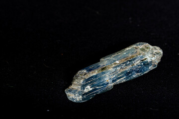 A five centimetre long blue kyanite crystal (Al2OSiO4) on a black background