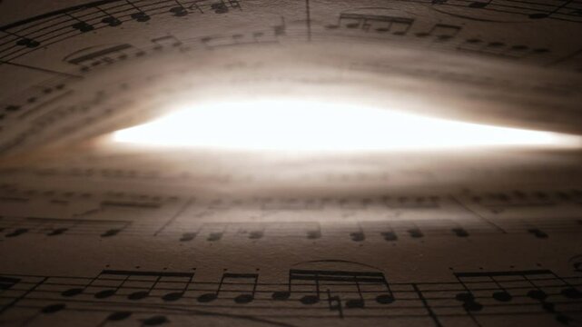 Slider macro background of saved medieval book with ancient musical notes writings. Texture of old handwritten classical symphony, beautiful melody, hobby concept. High quality 4k footage