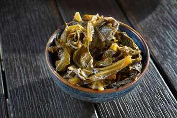 A view of a small bowl of collard greens.