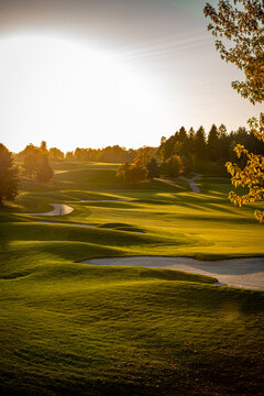 View of the golf course at sunset. A golf course fairway.