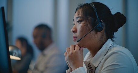 Modern call center office of mental health line: Close up portrait of Asian hotline specialist in...