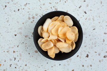 A top down view of a bowl of shrimp chips.