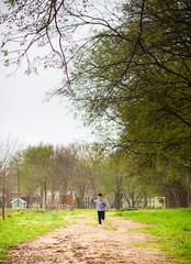 boy running on a path in the forest