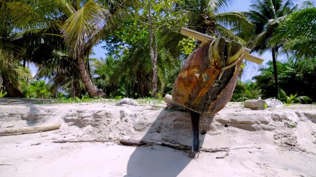 Traditional African longboat made of solid wood on a sandy beach among palm trees. Natural wood texture on an authentic African boat. Equatorial Guinea, Africa.