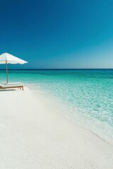 Obraz premium Serene beach view with a sun lounger and umbrella under a clear sky and calm waters