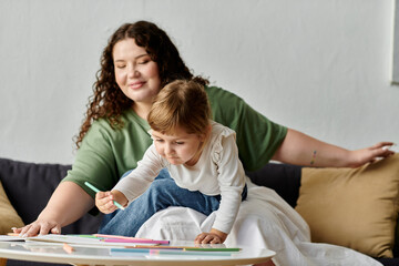 A joyful moment unfolds as a mother supports her daughter artistic exploration on the floor.