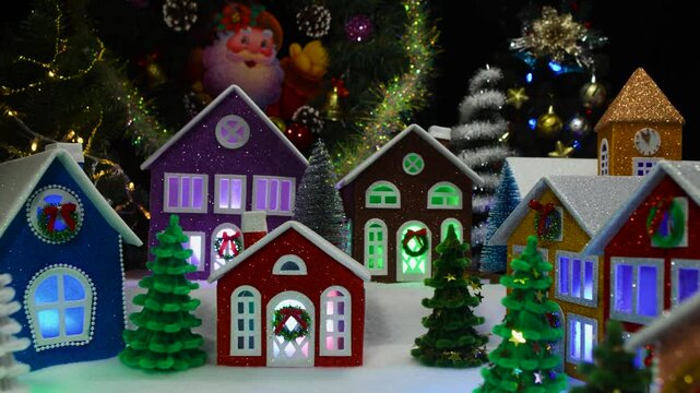 Christmas on the move a large Christmas town with colorful houses decorated with Christmas trees with lights in the windows and a chapel