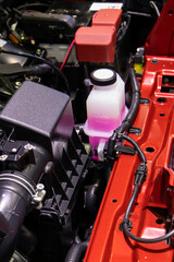 Fototapeta premium focused on the automotive industry within the contemporary new automobile engine room, machine displays all components and has an open hood. the new car's engine compartment.