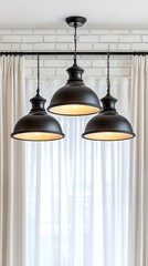 Obraz premium Modern pendant lights illuminate a cozy white room with sheer curtains and a stylish brick wall for minimalist elegance