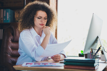 Photo of lovely curly young lady unsure thoughtful work papers dressed formalwear business manager...