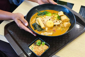 The staff is serving boiled sukiyaki shabu in a ready-to-eat cup.