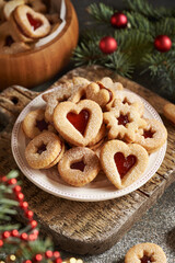 Homemade Linzer Christmas cookies filled with strawberry marmalade and dusted with sugar