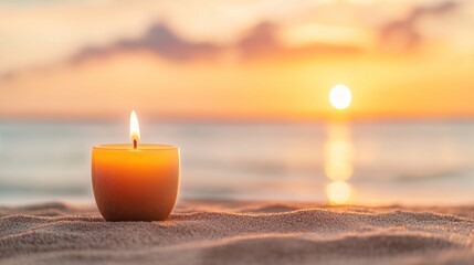 Tranquil candle lit on sandy beach at sunset with ocean horizon