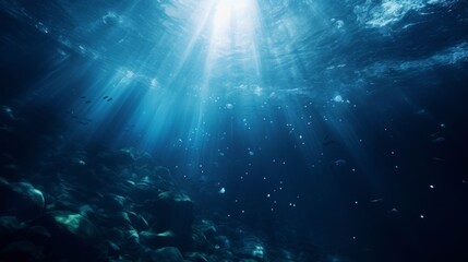 Dark blue underwater scene, surface above with light penetration