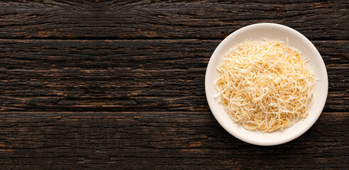 Cocos nucifera - Grated coconut with dehydrated sugar in the bowl.