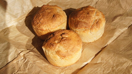 Bread three buns, golden crust bread, broken bread, on food paper, homemade baking, from white flour durum wheat, yeast baking, bread texture, Italy