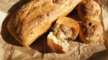 Bread, golden crust of bread, broken bread, different shapes on food paper, homemade baking, made...