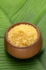 Crunchy yellow panko bread crumbs in a wooden bowl.