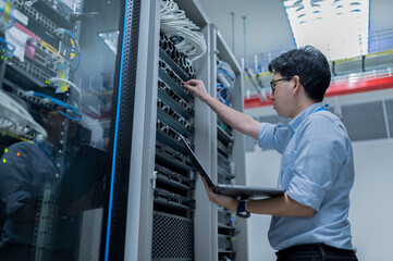 Computer engineer is setting up network in server room,Systems Maintenance Technician,Male engineer...