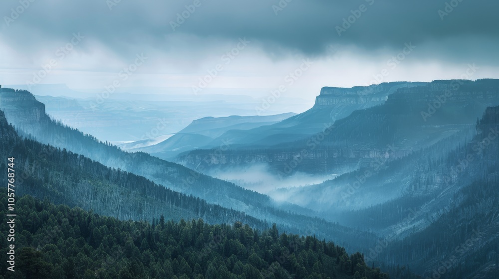 Poster layers of mountain ridges and forests beneath a moody sky